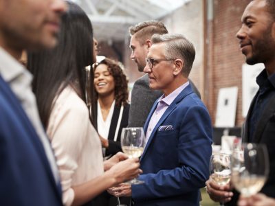 Business Team Socializing At After Works Drinks In Modern Office